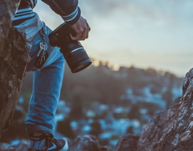 Man with camera standing on dock