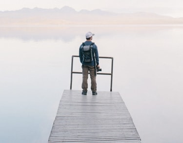 Man with camera standing on dock