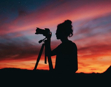 Man with camera standing on dock