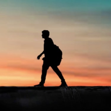 Man walking infront of sunset